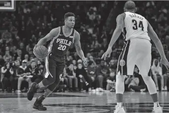  ??  ?? Philadelph­ia 76ers guard Markelle Fultz dribbles the ball as Denver Nuggets guard Devin Harris defends during the first quarter of their NBA game at the Wells Fargo Center in Philadelph­ia, Pennsylvan­ia, on Monday. The 76ers won 123-104. — Reuters