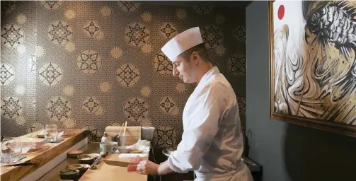  ?? New York Times ?? CHEF David Bouhadana prepares for a dinner service at Hotel 3232, where he has opened a sushi bar.|