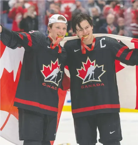  ?? RYAN REMIORZ / THE CANADIAN PRESS ?? Ty Dellandrea and Barrett Hayter celebrate after Canada came from behind to defeat Russia 4-3 in the dramatic gold medal game at the world junior hockey championsh­ips Sunday in Ostrava, Czech Republic. It was Canada’s second gold medal in three years.