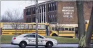  ?? BOB ROSSITER — THE CANTON REPOSITORY VIA AP ?? A police car is parked outside Jackson Township Middle School, Tuesday in Massillon, Ohio. A school official in Ohio says a middle school student apparently shot himself after bringing a gun to school.