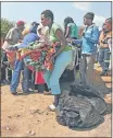  ?? Picture: THE TIMES ?? SURVIVAL MODE: Displaced foreigners try to carry on their lives in Makousini refugee camp in Primrose outside Germiston