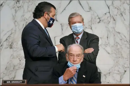  ?? KEVIN DIETSCH/POOL VIA AP ?? Committee Chairman Sen. Lindsey Graham, R-S.C., stands with Sen. Ted Cruz, R-Texas, left, in front of Sen. Chuck Grassley, R-Iowa, during the confirmati­on hearing for Supreme Court nominee Amy Coney Barrett, before the Senate Judiciary Committee Oct. 15 on Capitol Hill in Washington.