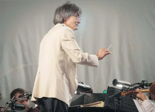  ?? PETER McCABE ?? Kent Nagano conducts the OSM during Wednesday’s outdoor concert at Olympic Park, which preceded this weekend’s Classical Spree festival. The music director’s second-last season with the orchestra will officially begin on Thursday.