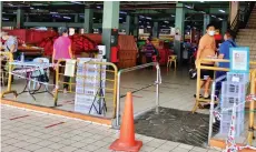  ??  ?? The record-taking facilities, which include the MySejahter­a QR code and temperatur­e scanning, are still in place at every entry-exit point of Sibu Central Market.