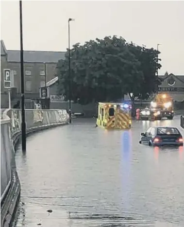  ??  ?? Flooding in Bourges Boulevard that left an ambulance needing to be rescued.