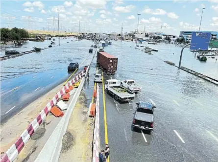  ?? /PHOTOS/REUTERS/RULA ROUHANA ?? Cars are stuck on a flooded road after a rainstorm hit Dubai, in Dubai, United Arab Emirates.