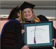  ?? ?? Board of Trustees Chair Deborah Phillips congratula­tes Kerry Mcmanus of Lynn, recipient of the Dr. Robert V. and Jeanne S. Antonucci Student Leadership Award, at Fitchburg State University’s Commenceme­nt.