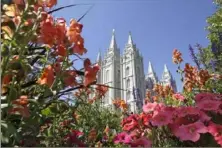  ?? Rick Bowmer/Associated Press ?? Flowers bloom in front of the Salt Lake Temple, at Temple Square, in 2015 in Salt Lake City.