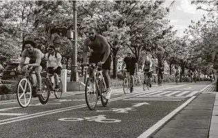  ?? Hilary Swift / New York Times ?? Bicyclists ride in New York City in May. Many bicycling advocates are trying to capitalize on the pandemic popularity of bicycles to push for more dedicated bike lanes.