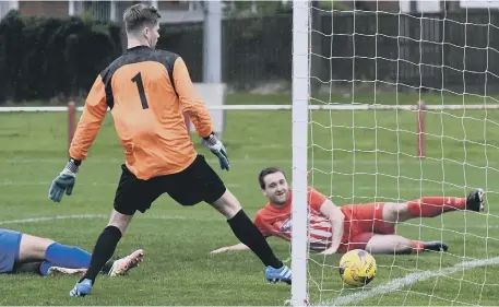  ??  ?? James Ellis completes his hat-trick from close range to put Ryhope CW 6-1 up against Harrogate RA. Pictures by Kevin Brady.