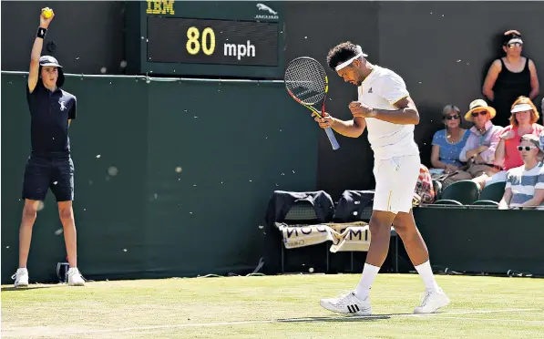  ??  ?? Jo-wilfried Tsonga tries to keep his cool amid the swarm of flying ants that descended on Wimbledon. Players and fans alike described their struggles to brush off the insects, which are likely to remain for several days