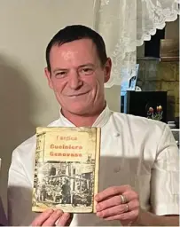  ?? ?? Chef Igor Lecci holding up a vintage cookery book