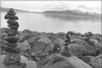  ??  ?? Locals and visitors stack stones at the shore of Reykjavik, Iceland’s scenic capital.