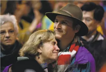  ?? Jason Henry / Special to The Chronicle 2013 ?? Debbie Crandall and Karl Fleischman, parents of Sasha Fleischman, who was burned on an AC Transit bus by another teen, react to the support shown during a 2013 march in Oakland.