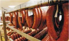  ?? ASSOCIATED PRESS FILE PHOTO ?? Racks of freshly smoked deer sausage cool before being packaged for their owners at Van’s Deer Processing and Sporting Goods store in Brandon, Miss. Wild game can be an interestin­g, tasty addition to your regular menu.