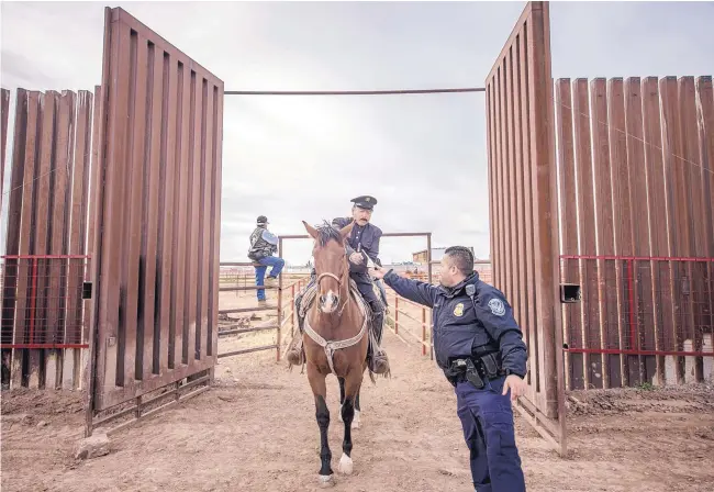  ?? ROBERTO E. ROSALES/JOURNAL ?? Narciso Martinez, who plays the character of Pancho Villa, hands a Border Patrol agent his passport as he enters the United States from Mexico to participat­e in last year’s Binational Cavalcade re-enactment in Columbus, N.M.