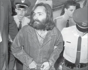  ?? Bill Murphy Los Angeles Times ?? CHARLES MANSON is escorted into court for a hearing Dec. 3, 1969. By the time he and his crew were convicted in the Tate-LaBianca killings, his son known as “Pooh Bear” was living with grandparen­ts in Wisconsin.
