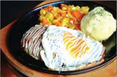  ??  ?? Served: A Teritama Hamburg Steak with a runny egg, mashed potato and veggies on the side.
