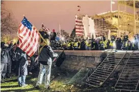  ?? JASON ANDREW/THE NEW YORK TIMES ?? Supporters of then-President Donald Trump face police Jan. 6 outside the U.S. Capitol. Five people, including a police officer, died in a riot that day.