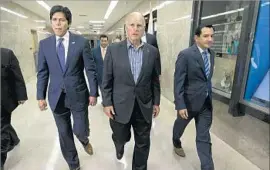  ?? Rich Pedroncell­i Associated Press ?? GOV. BROWN, flanked by Senate President Pro Tem Kevin de León, left, and Assembly Speaker Anthony Rendon, supports a package of housing bills.