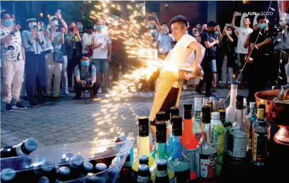  ??  ?? May 24, 2020: A bartender performs at a night fair of Sinan Mansions in Shanghai, eastern China. The night fair with food stalls and openair art exhibition­s opened to boost Shanghai’s nighttime economy. by Chen Fei/xinhua
