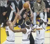  ?? KEVIN REECE Special to the VP ?? Lakers forward Anthony Davis (3) goes to the basket against Denver Nuggets forward Aaron Gordon (50), forward Justin Holiday (9) and Reggie Jackson (7) on Thursday in Los Angeles.