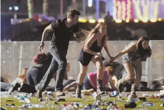  ?? GETTY IMAGES FILE PHOTO ?? ‘PROFOUNDLY WRONG’: People run from the Route 91 Harvest country music festival in Las Vegas on Oct. 1, 2017.