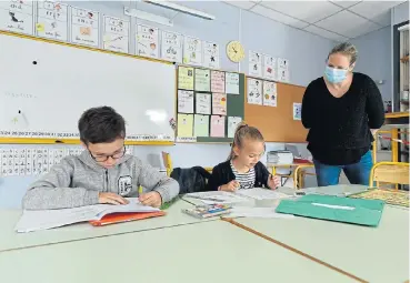  ?? /AFP ?? Classes resume:
A teacher wearing a protective face mask gives a lesson at the Alix de Bretagne school in Saint-Aubin-du-Cormier, France, as schools in the country are to gradually reopen from May 11.