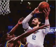  ?? AP ?? Thunder’s Steven Adams (12) is fouled by Warriors’ Kevin Durant (left) during the third quarter on Saturday.