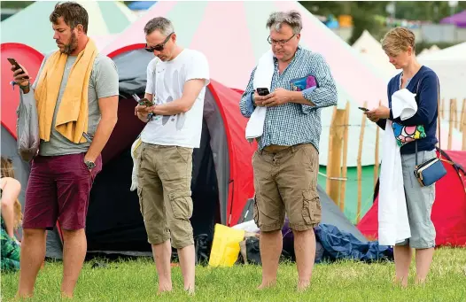  ??  ?? In line: Former shadow chancellor Ed Balls and his wife, Labour MP Yvette Cooper, right, queue for the festival showers