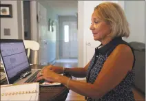  ?? Brian A. Pounds / Hearst Connecticu­t Media ?? Carole Ardito, president of the North Haven Education Associatio­n, the teachers union in North Haven, works on preparatio­ns for the new school year at her home in Branford on July 9.