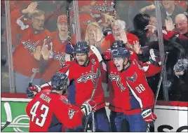  ?? KASTER/THE ASSOCIATED PRESS] [CAROLYN ?? Washington Capitals left wing Alex Ovechkin (8) celebrates scoring against the Pittsburgh Penguins with teammates Tom Wilson, Kevin Shattenkir­k and Nate Schmidt during the third period Saturday in Washington.