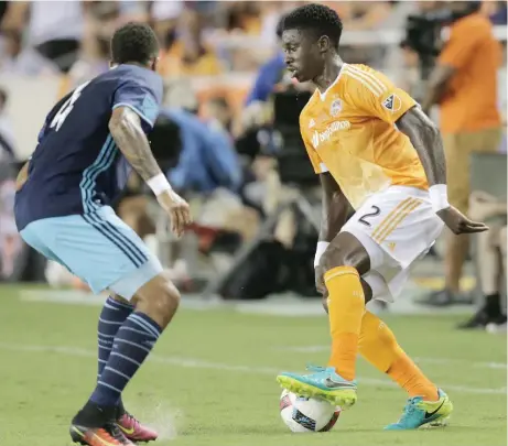  ?? Elizabeth Conley / Houston Chronicle ?? Dynamo defender Jalil Anibaba, right, tries a little footwork to evade Sounders FC defender Tyrone Mears this past season. The Dynamo open the season against Seattle at BBVA Compass Stadium tonight as coach Wilmer Cabrera tries to take the club back to...