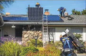  ?? Mel Melcon Los Angeles Times ?? WORKERS FROM Sunrun install solar panels in Granada Hills. Big power plants are being joined by programmab­le thermostat­s, electric cars and smart plugs as tools to balance electricit­y supply and demand.