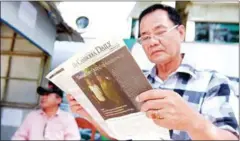  ?? AFP ?? A man reads the in Phnom Penh on its last day of publicatio­n after it was forced to close in 2017 over a massive tax bill.