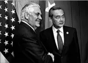  ?? ROUELLE UMALI/XINHUA ?? Secretary of State Rex Tillerson, left, and Chinese Foreign Minister Wang Yi pose before a bilateral meeting Sunday.