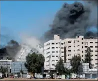 ??  ?? Gaza tower housing Al Jazeera and other media houses is seen during a missile strike in Gaza city on Saturday.