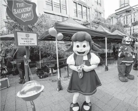  ??  ?? Mascot Sally Ann helps launch the Salvation Army Christmas Kettle Campaign at Uptown shopping centre on Saturday, with Victoria Royals’ Marty the Marmot lending support. The red kettles will line the streets for the next six weeks.