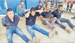  ?? Picture: AP ?? Suspects in the assassinat­ion of Haiti’s President Jovenel Moise sit on the floor handcuffed after being detained, at the General Direction of the police in Port-au-Prince, Haiti on Thursday.