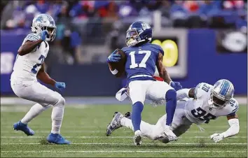  ?? Dustin Satloff / TNS ?? The Lion’s Jerry Jacobs (39) tackles Giants receiver Wan’Dale Robinson during the second half on Sunday in East Rutherford, N.J.