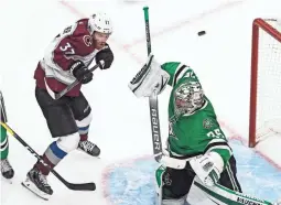  ?? JASON FRANSON/THE CANADIAN PRESS VIA AP ?? Stars goalie Anton Khudobin (35) makes a save as the Avalanche’s J.T. Compher (37) screens during the third period on Sunday.