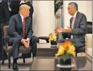  ?? AP/MINISTRY OF COMMUNICAT­IONS AND INFORMATIO­N SINGAPORE ?? U.S. President Donald Trump (left) and Singapore Prime Minister Lee Hsien Loong talk ahead of a summit with North Korean leader Kim Jong Un on Monday.