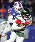  ?? JOSHUA BESSEX - AP ?? The Buffalo Bills’ Jordan Poyer, left, sacks New York Jets quarterbac­k Zach Wilson during the second half of an NFL game, Sunday, in Orchard Park, N.Y.