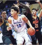  ?? COMMERCIAL APPEAL MARK WEBER, THE ?? Memphis forward Isaiah Maurice (middle) drives the lane against a trio of Oklahoma State defenders during first round action in the Advocate Invitation­al in Orlando Thursday, November 22, 2018.