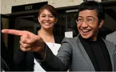  ?? — AFP photo ?? Ressa (right) reacts outside the Pasig Regional Trial Court following her acquittal in a tax evasion case in Pasig, Metro Manila.
