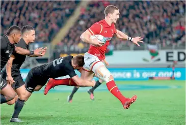  ??  ?? New Zealand All Blacks Beauden Barret (L) tackles Wales' George North (R) during the rugby Test match between the New Zealand All Blacks and Wales at Eden Park in Auckland on June 11, 2016. - AFP