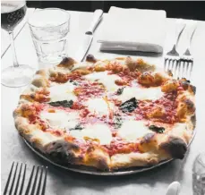  ?? Stephen Lam / Special to The Chronicle ?? Margherita pizza at Pizzeria Delfina is a must-try classic.