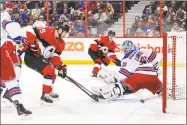  ?? Jana Chytilova/Freestyle Photo / Getty Images ?? The Senators’ Derick Brassard tips the puck past Rangers goalie Henrik Lundqvist in the second period at Canadian Tire Centre in Ottawa on Saturday.