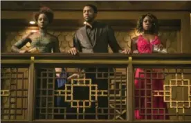  ?? MATT KENNEDY — MARVEL STUDIOS — DISNEY VIA AP ?? This image released by Disney and Marvel Studios’ shows Lupita Nyong’o, from left, Chadwick Boseman and Danai Gurira in a scene from “Black Panther.”
