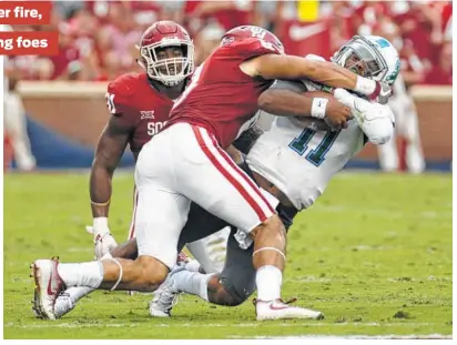  ?? Mitch Alcala / Associated Press ?? Oklahoma defenders such as Kahlil Haughton have bottled up opponents this season, as Tulane QB Johnathan Brantley learned the hard way.